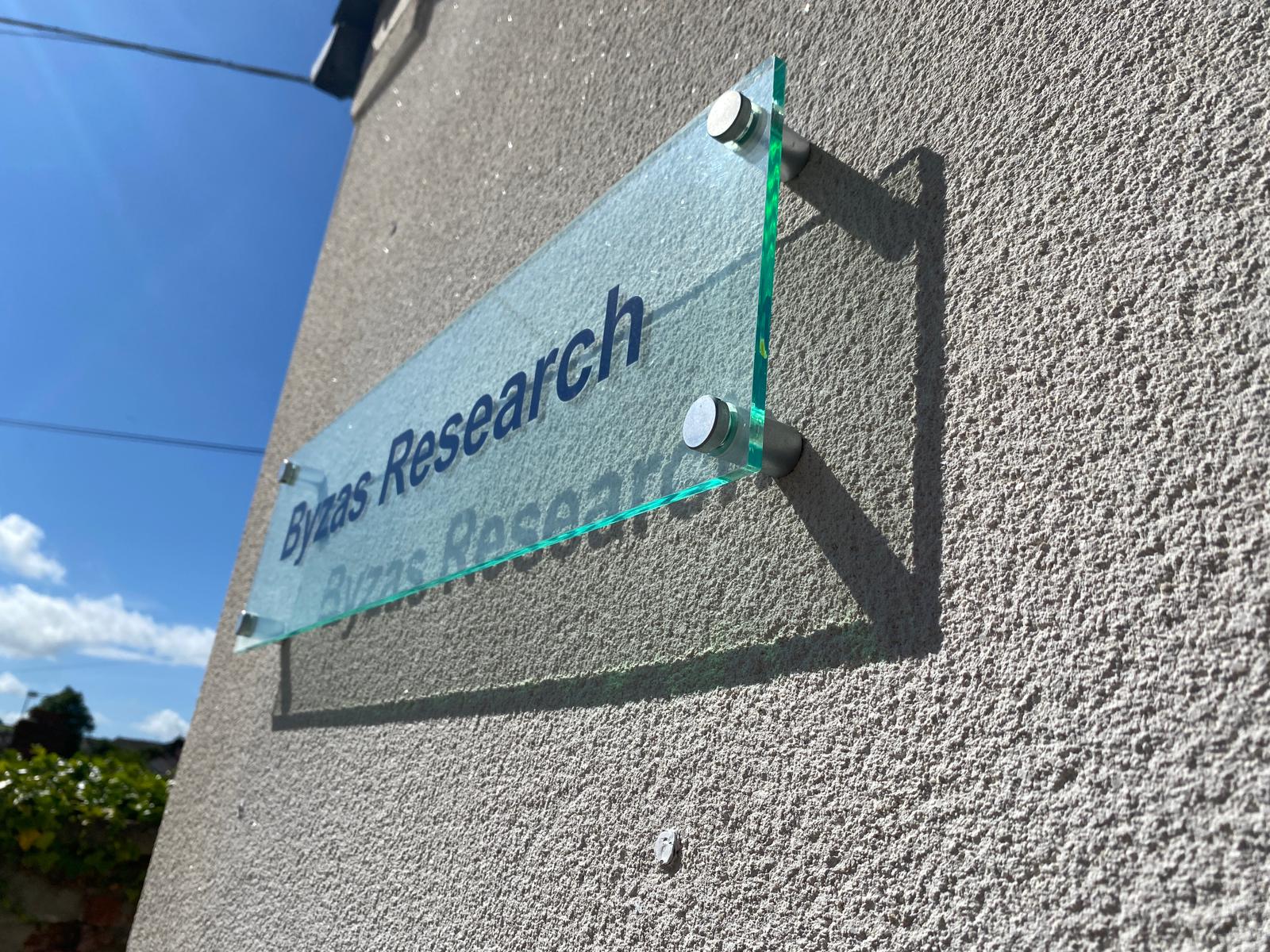 Byzas Research glass plaque fixed to exterior wall
